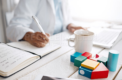 Buy stock photo Shot of a female doctor making notes while working