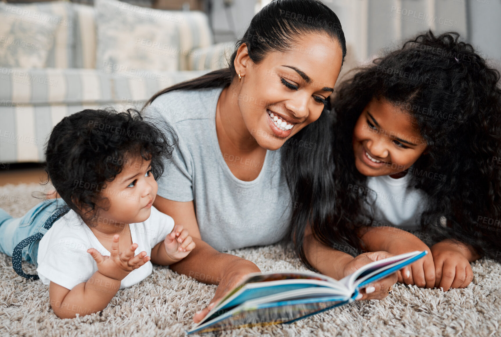 Buy stock photo Happy mother, children and reading with book on floor for story, bonding or childhood development at home. Mom, baby and kid with novel or storytelling for learning, education or fairy tale at house