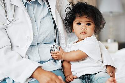 Buy stock photo Shot of a little baby girl holding onto the stethoscope of her doctor