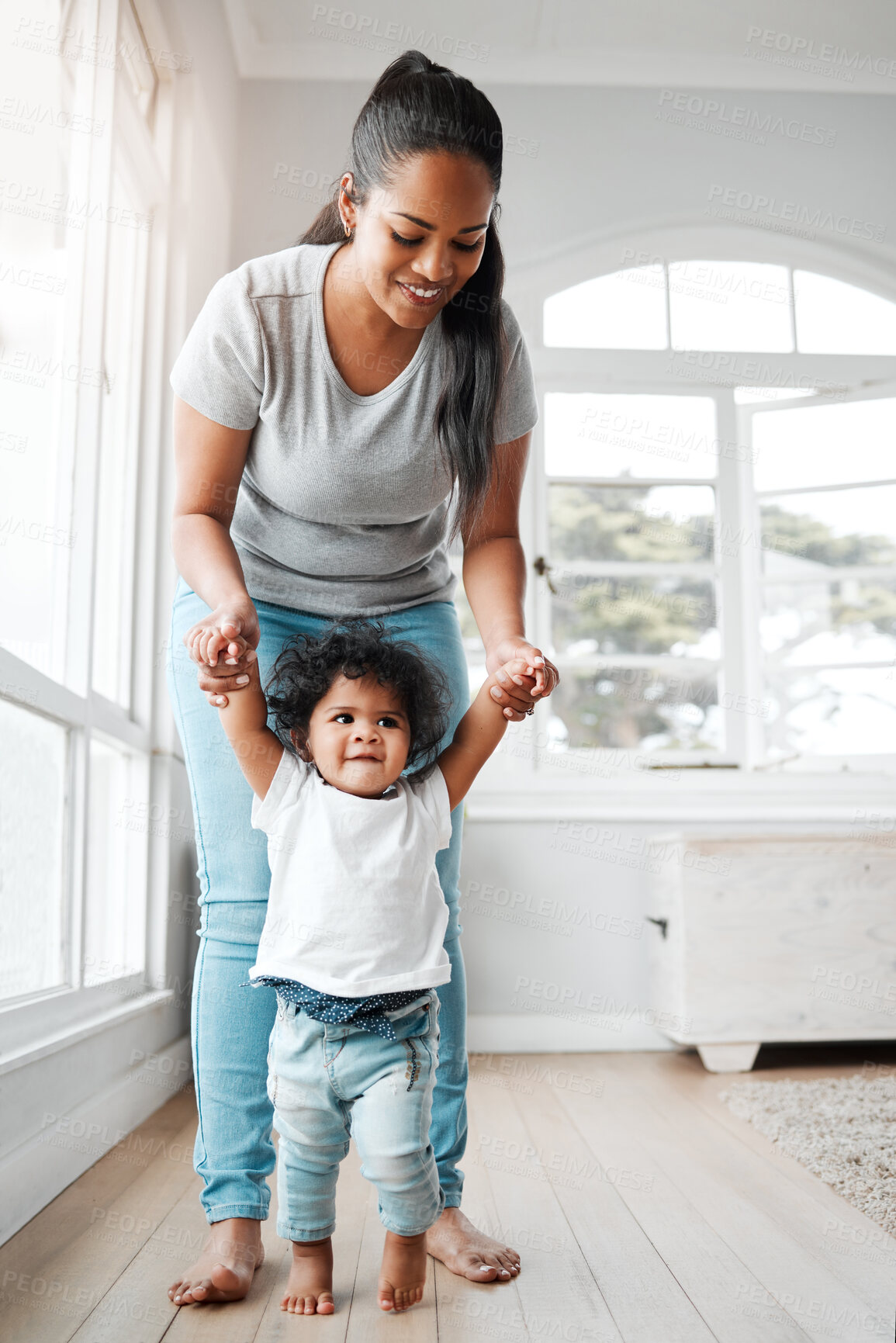 Buy stock photo Walking, learning and love with mother, baby and support for growth, development and motor skills. Female person, child and care in home or living room for bonding, together and teaching as family