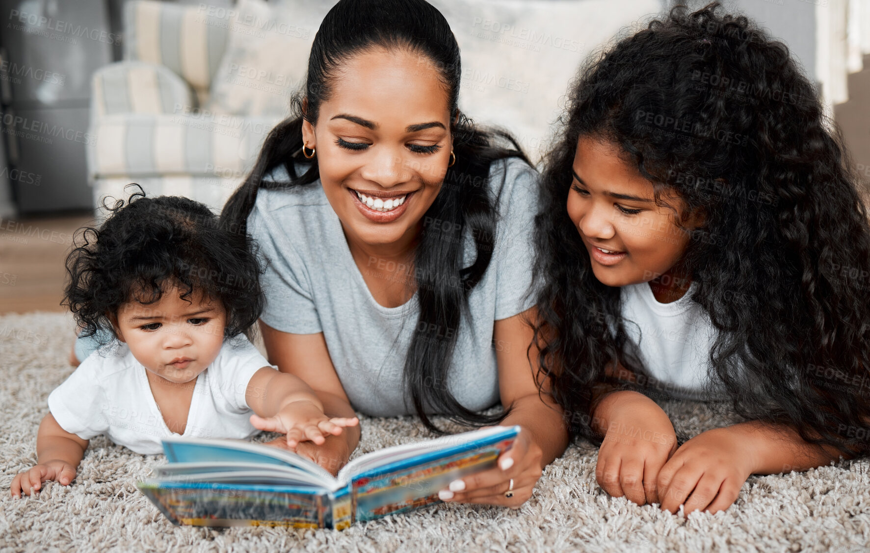 Buy stock photo Happy mom, children and reading with book on floor for story, bonding or childhood development at home. Mother, baby and kid with novel or storytelling for learning, education or fairy tale at house