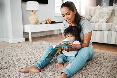 Buy stock photo Mother, baby and reading with book on floor for story, bonding or early childhood development at home. Mom, child or young kid with novel for learning, education or fairy tale in living room at house