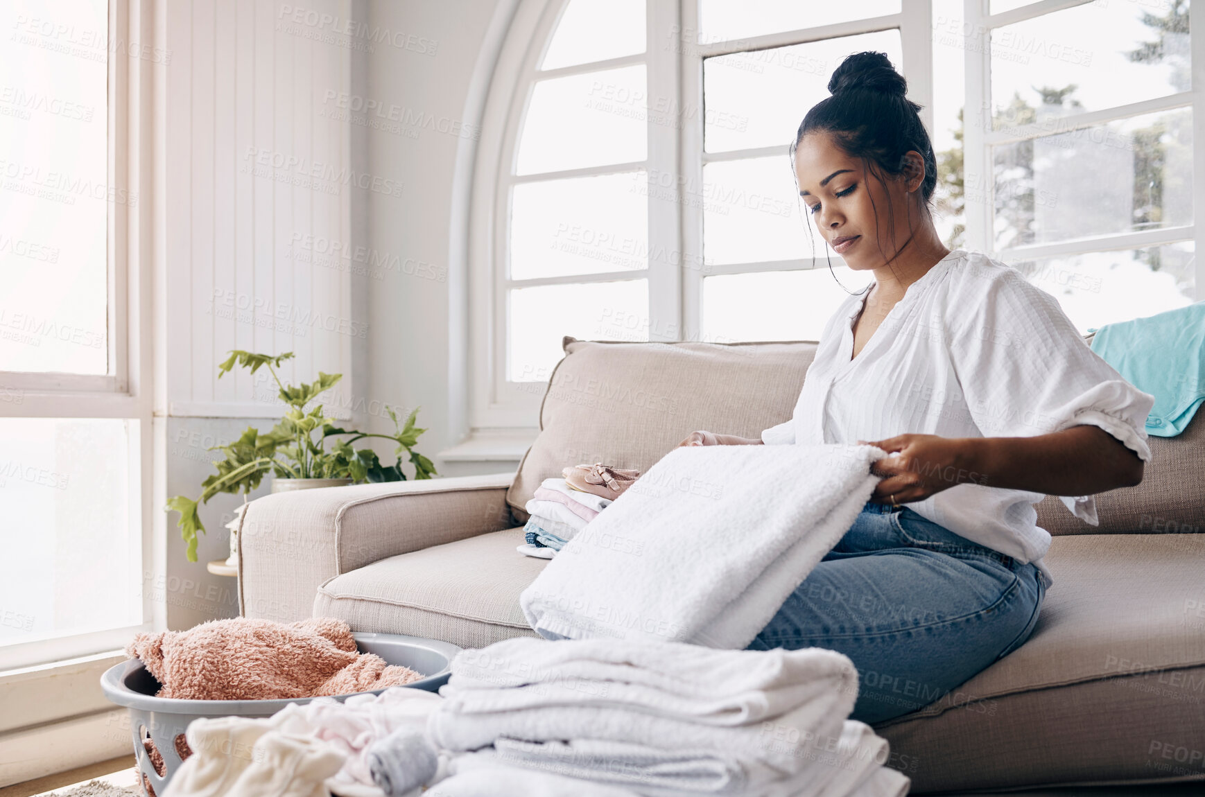 Buy stock photo Fold, cleaning and woman in home for laundry for organizing clothes and washing in living room. Cotton, basket and housekeeping cleaner with fabric, garment or towel in morning routine for wellness