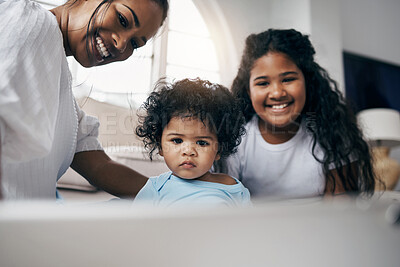 Buy stock photo Shot of an attractive young woman sitting on the living room floor with her children and using a digital tablet