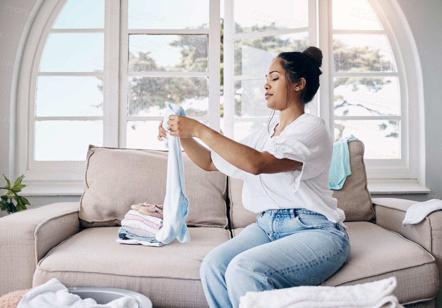 Buy stock photo Fold, cleaning and woman in home with clothes for organizing laundry and washing in living room. Cotton, basket and housekeeping cleaner with fabric, garment or towel in morning routine for wellness