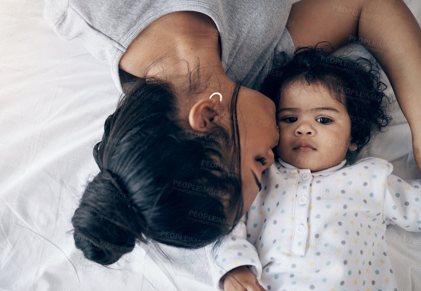 Buy stock photo Love, mother and kiss baby on bed for comfort, child development and morning routine with bonding. Top view, woman and infant in bedroom with affection, protection and relationship with connection