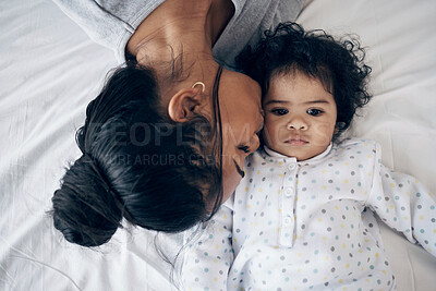 Buy stock photo Shot of a young mother bonding with her baby girl in bed at home