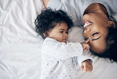Buy stock photo Shot of a young mother bonding with her baby girl in bed at home