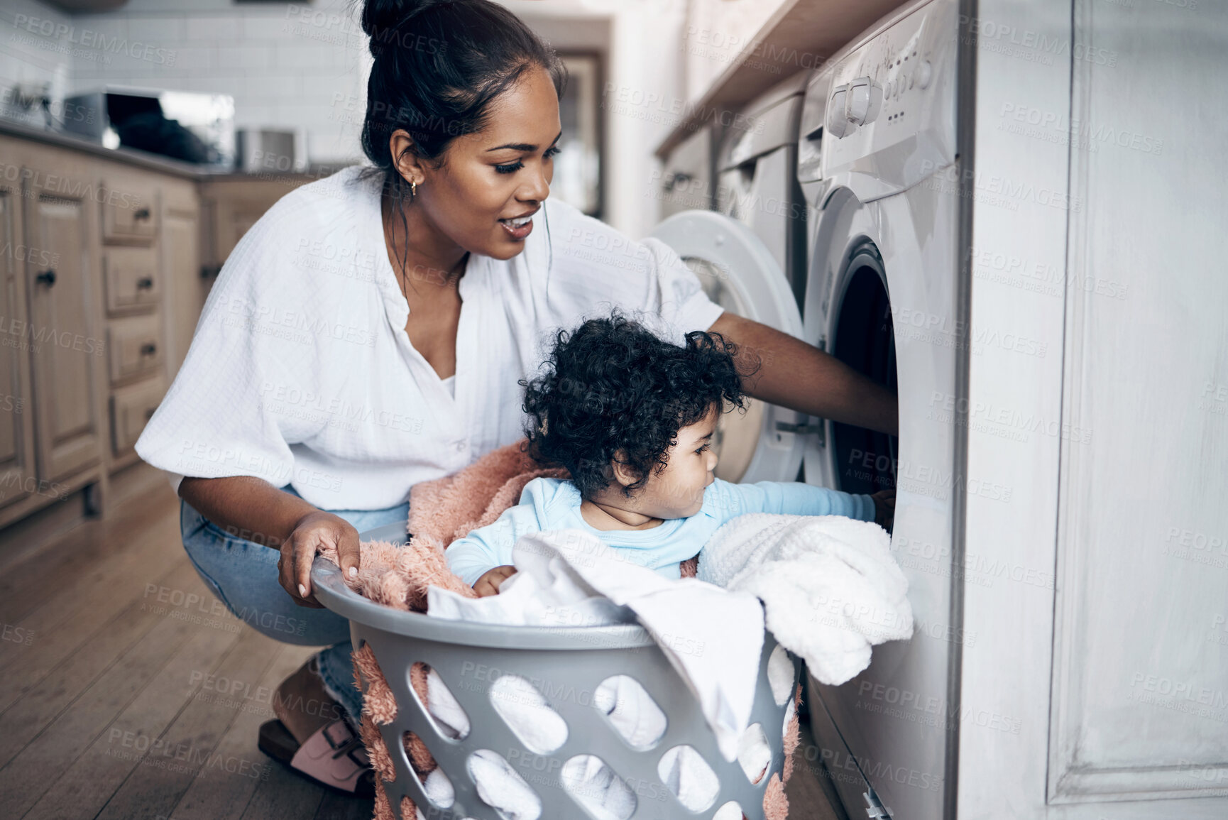 Buy stock photo Mother, baby and washing machine for laundry in home, helping mom and multitask with chores. Mama, support daughter and housekeeping with child in kitchen, cleaning and loading clothes in routine