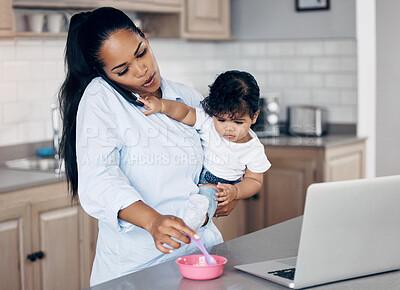 Buy stock photo Shot of a young mother feeding her baby while using a laptop at home