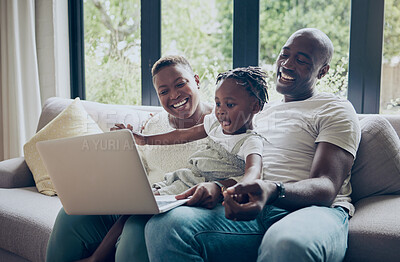 Buy stock photo Shot of a young family using a laptop together at home