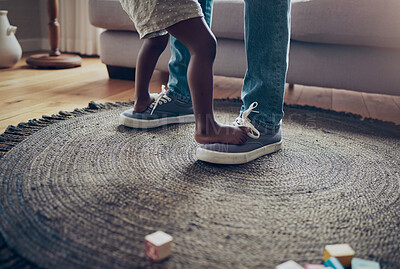 Buy stock photo Shot of an unrecognizable parent and child dancing together at home