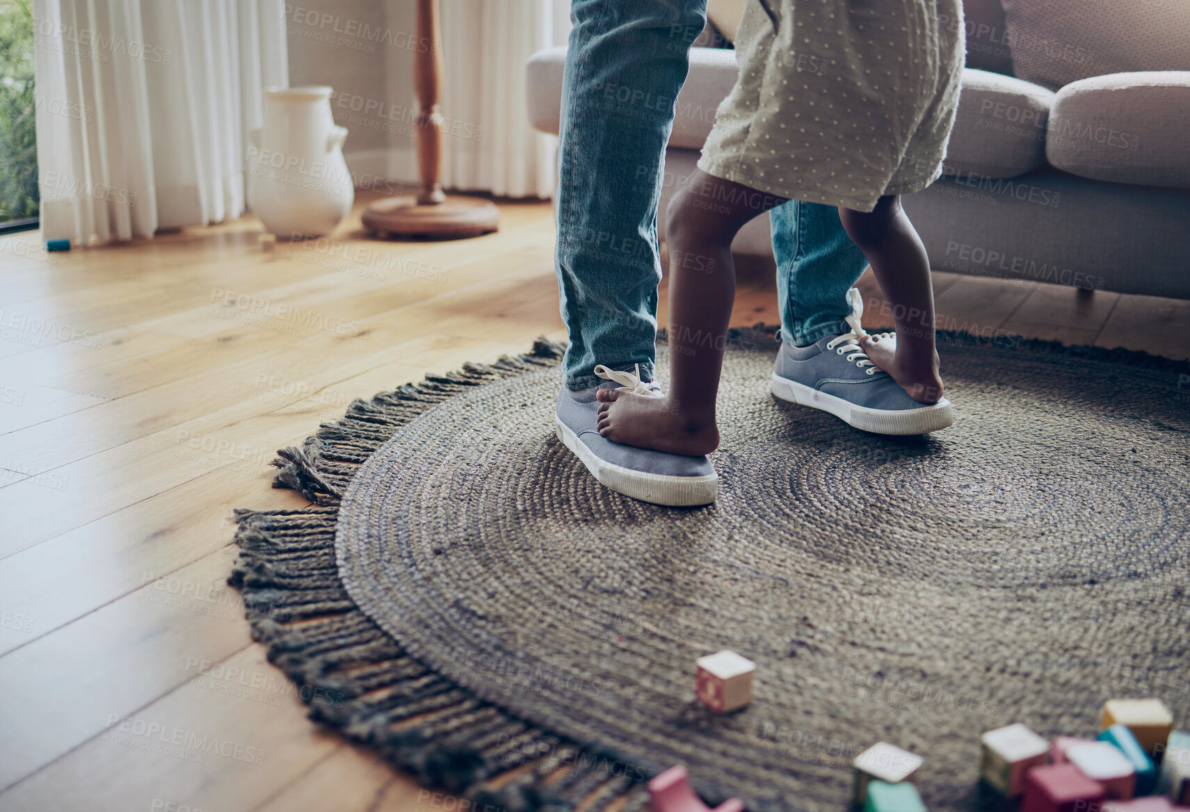 Buy stock photo Shot of an unrecognizable parent and child dancing together at home