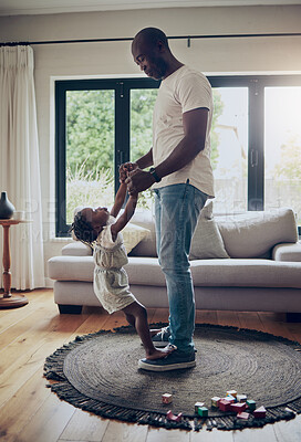 Buy stock photo Shot of a little girl dancing with her father in the lounge at home