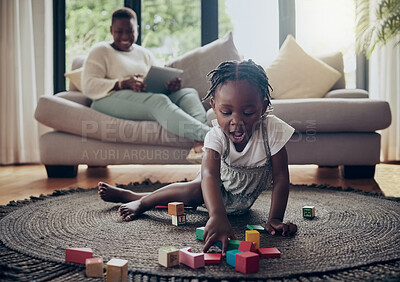 Buy stock photo Shot of a little girl playing with blocks at home