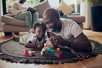 Buy stock photo Shot of a little girl and her father playing with blocks at home