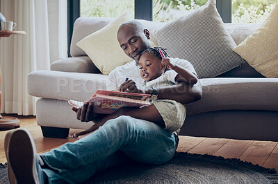 Buy stock photo Shot of a father drawing in a book with his daughter at home