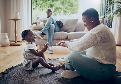 Buy stock photo Shot of a young mother playing with her daughter at home