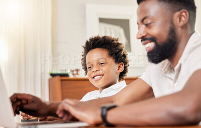 Buy stock photo Shot of a father and son using a laptop together at home