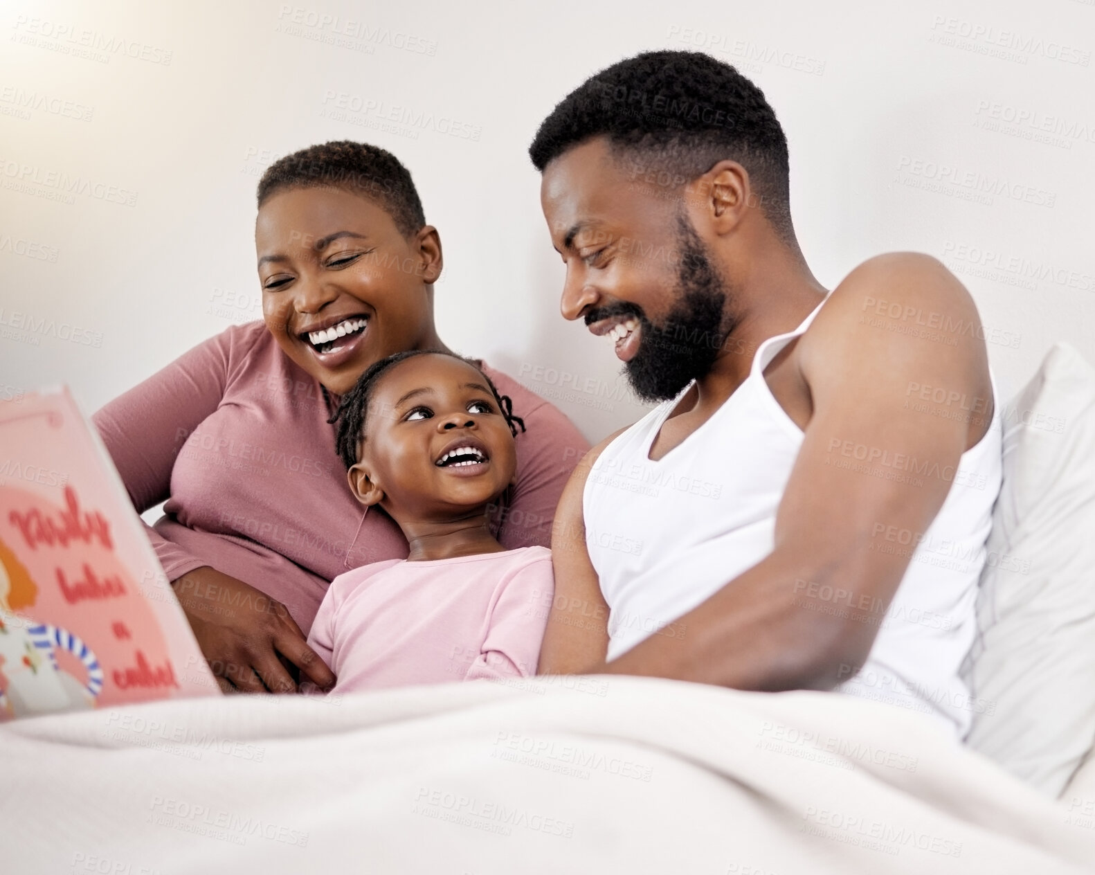 Buy stock photo Parents, reading and child with book in bed for learning language in story and education in home. Funny, black family or kid relax with creative fairytale for development of literacy with mom and dad