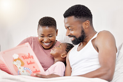 Buy stock photo Shot of a young family bonding in bed together