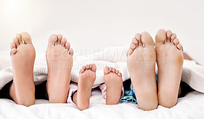 Buy stock photo Shot of a family's bare feet while sleeping in bed together