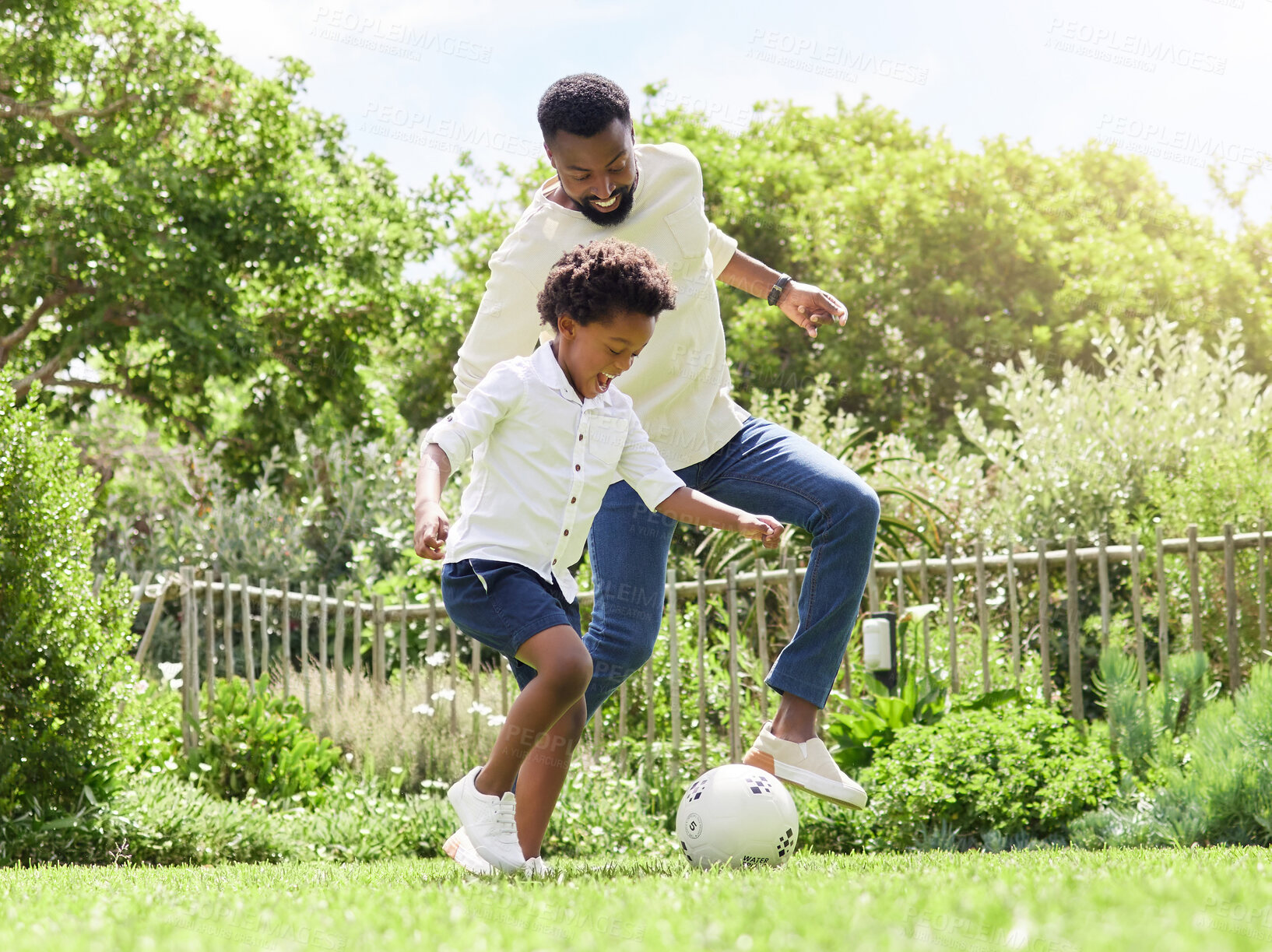 Buy stock photo Soccer, happy dad and kid on a garden with exercise, sport learning and goal kick together. Lawn, fun game and black family with football on grass with youth, sports development and bonding on field