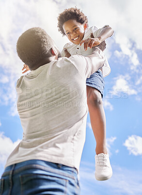 Buy stock photo Low angle shot of a little boy being lifted up to the sky by his father outdoors