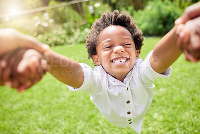 Buy stock photo Portrait of a little boy being swung around by his father outdoors