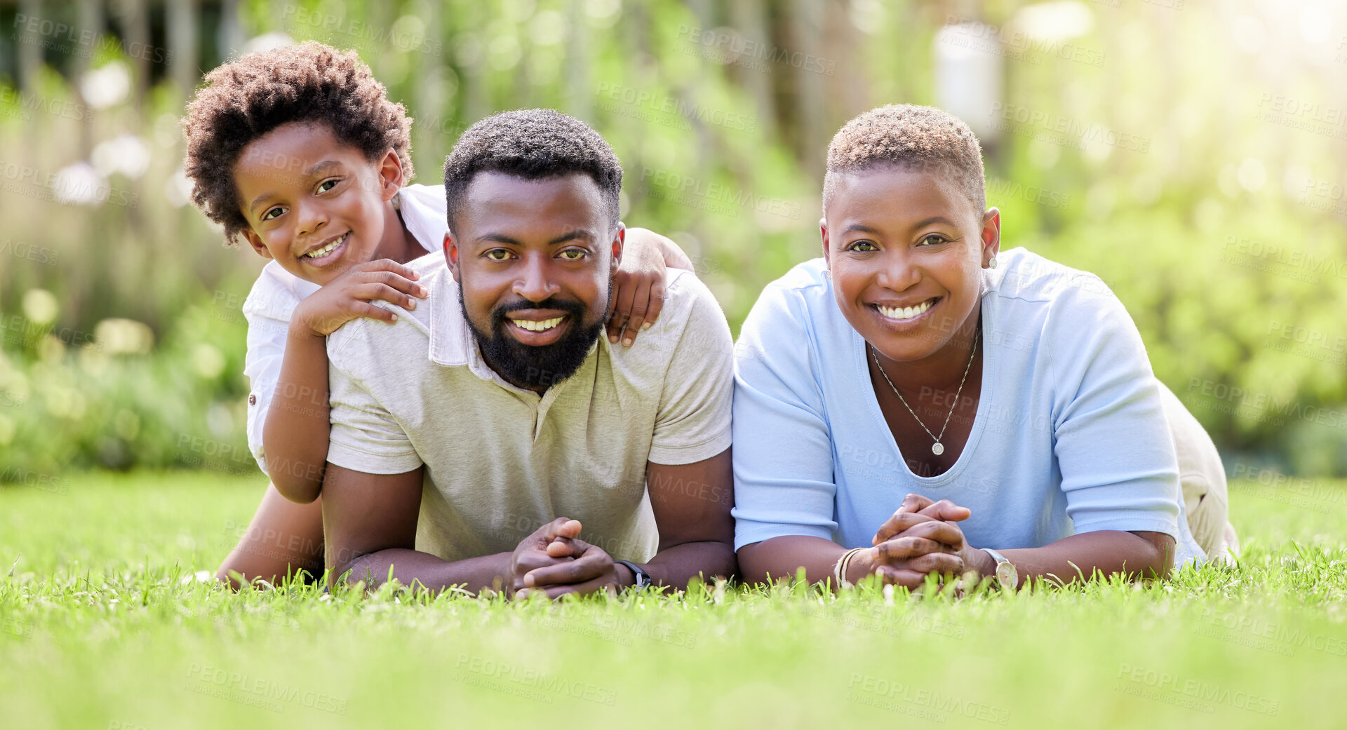 Buy stock photo Portrait, black family and parents with kid, grass in backyard and outdoor weekend fun together. Happiness, love and sun, mother and father with children relax and smile in summer garden or lawn