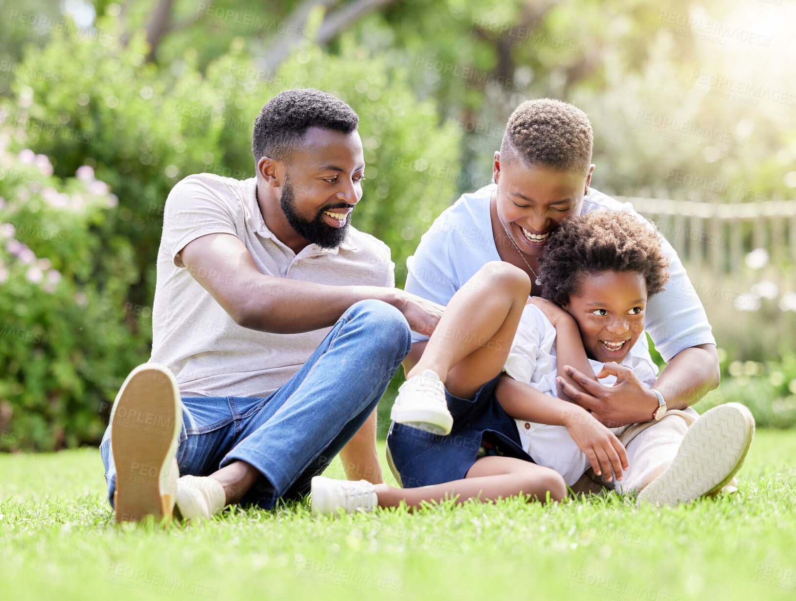 Buy stock photo Happy, black family and relax with grass field for love, care or bonding on holiday, weekend or summer break at park. African mother, father and son with smile for playful day or embrace in nature