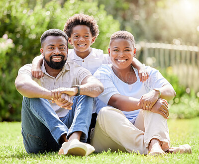 Buy stock photo Portrait of a happy family relaxing together on the lawn outdoors