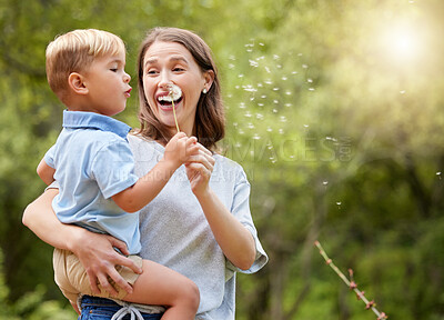 Buy stock photo Nature, mother and child blowing dandelion for wishing, hope and childhood in meadow together. Spring, family and happy mom with boy with wildflower in field for adventure, freedom and happiness