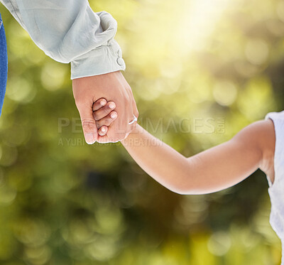 Buy stock photo Shot of an unrecognizable child and parent holding hands in nature