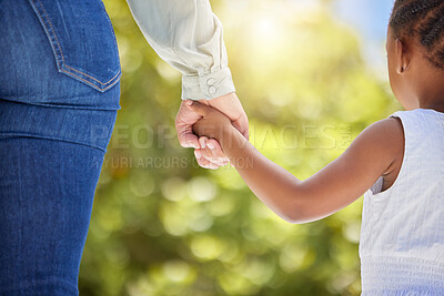 Buy stock photo Shot of an unrecognizable child and parent holding hands in nature