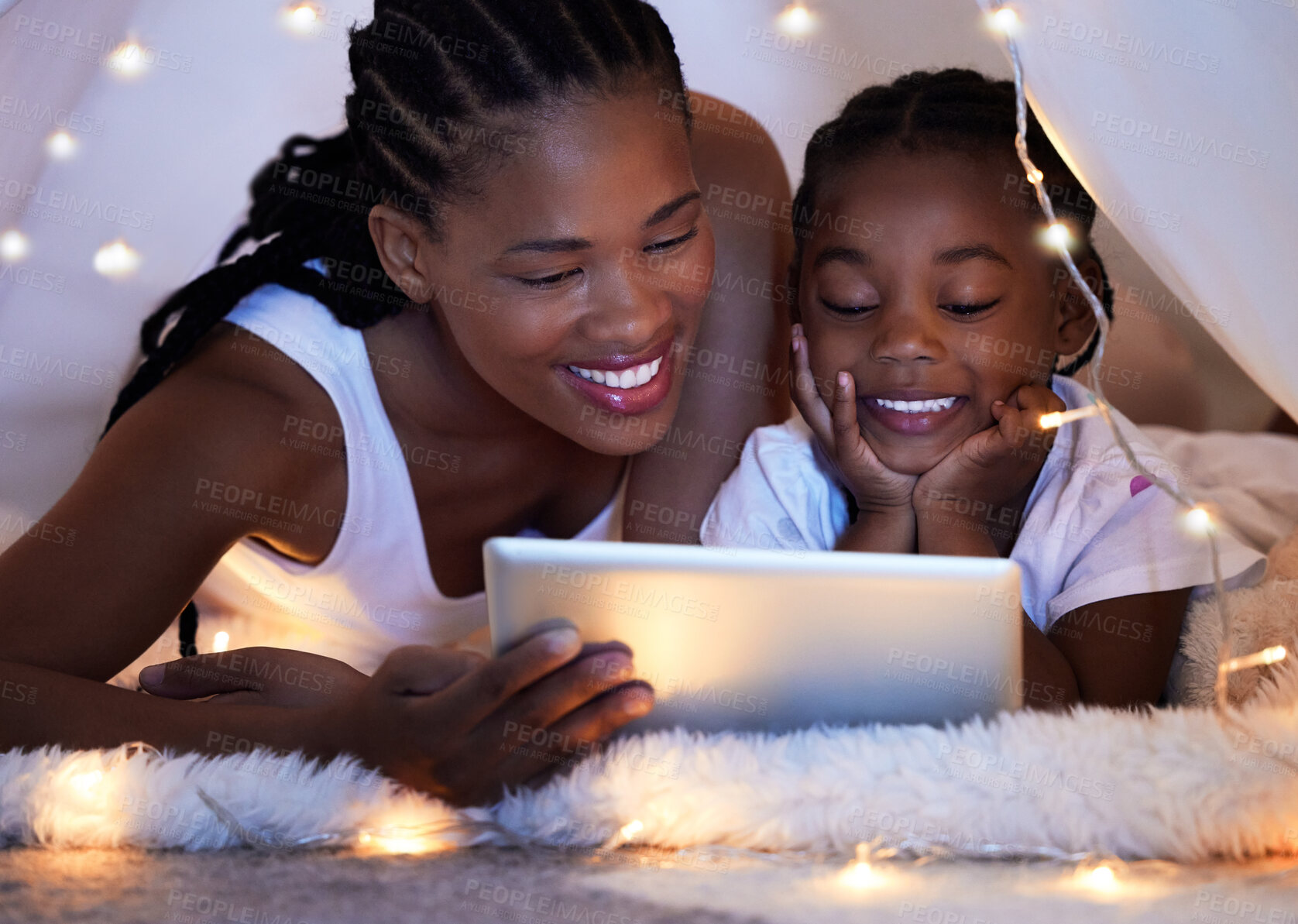 Buy stock photo Tablet, relax and mother with child in tent watching movie, video or show online in bedroom at home. Smile, love and African mom with girl kid in blanket fort streaming film on digital technology.