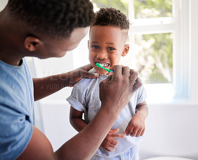 Buy stock photo African father, teaching son and toothbrush with care, love or support for cleaning, hygiene or dental wellness. Black man, boy and brushing teeth in home bathroom with health, smile and helping hand