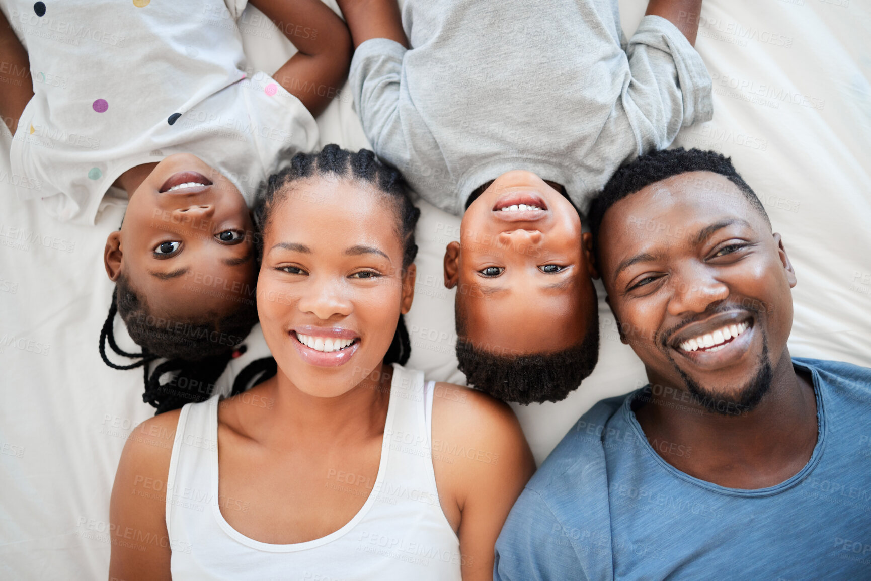 Buy stock photo Top view, bed and portrait of parents with children bonding, happiness and having fun on weekend. African people, black family and mother with father and love together in bedroom to relax in morning