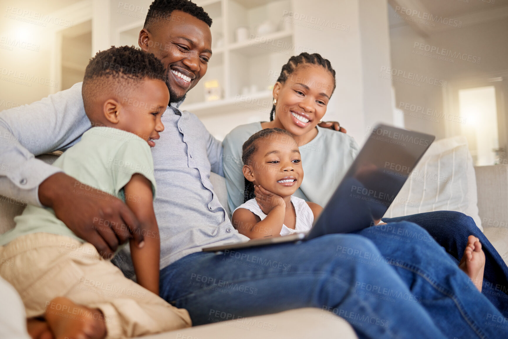 Buy stock photo Shot of a young african family watching movies together on the couch
