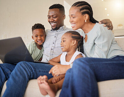 Buy stock photo Shot of a young african family watching movies on a laptop together