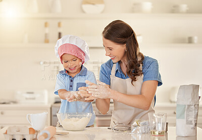 Buy stock photo Shot of a young mother baking with her son