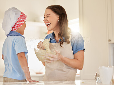 Buy stock photo Shot of a young mother baking with her son
