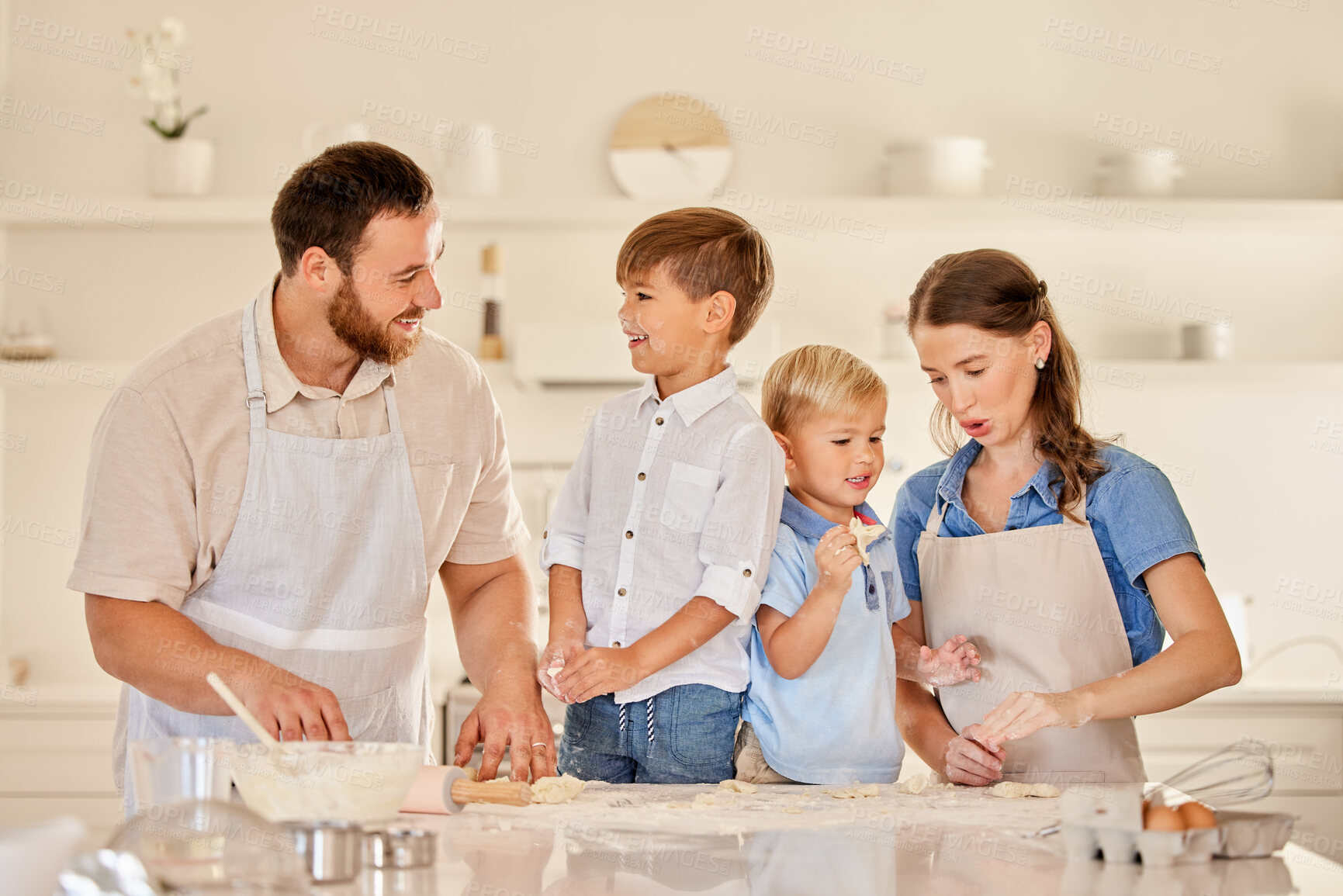 Buy stock photo Shot of a young family baking together