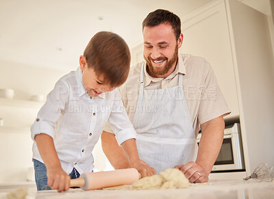 Buy stock photo Shot of a young man rolling out dough with his son