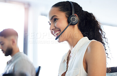 Buy stock photo Shot of an attractive young call centre agent sitting in the office with her colleague