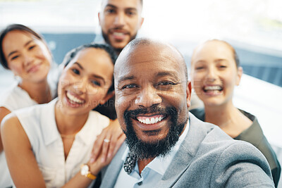 Buy stock photo Shot of a diverse group of businesspeople standing together in the office and taking selfies