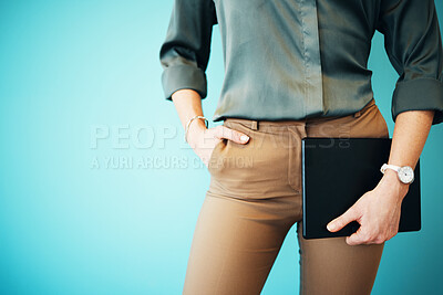 Buy stock photo Cropped shot of an unrecognisable businesswoman standing alone in the office and holding a digital tablet