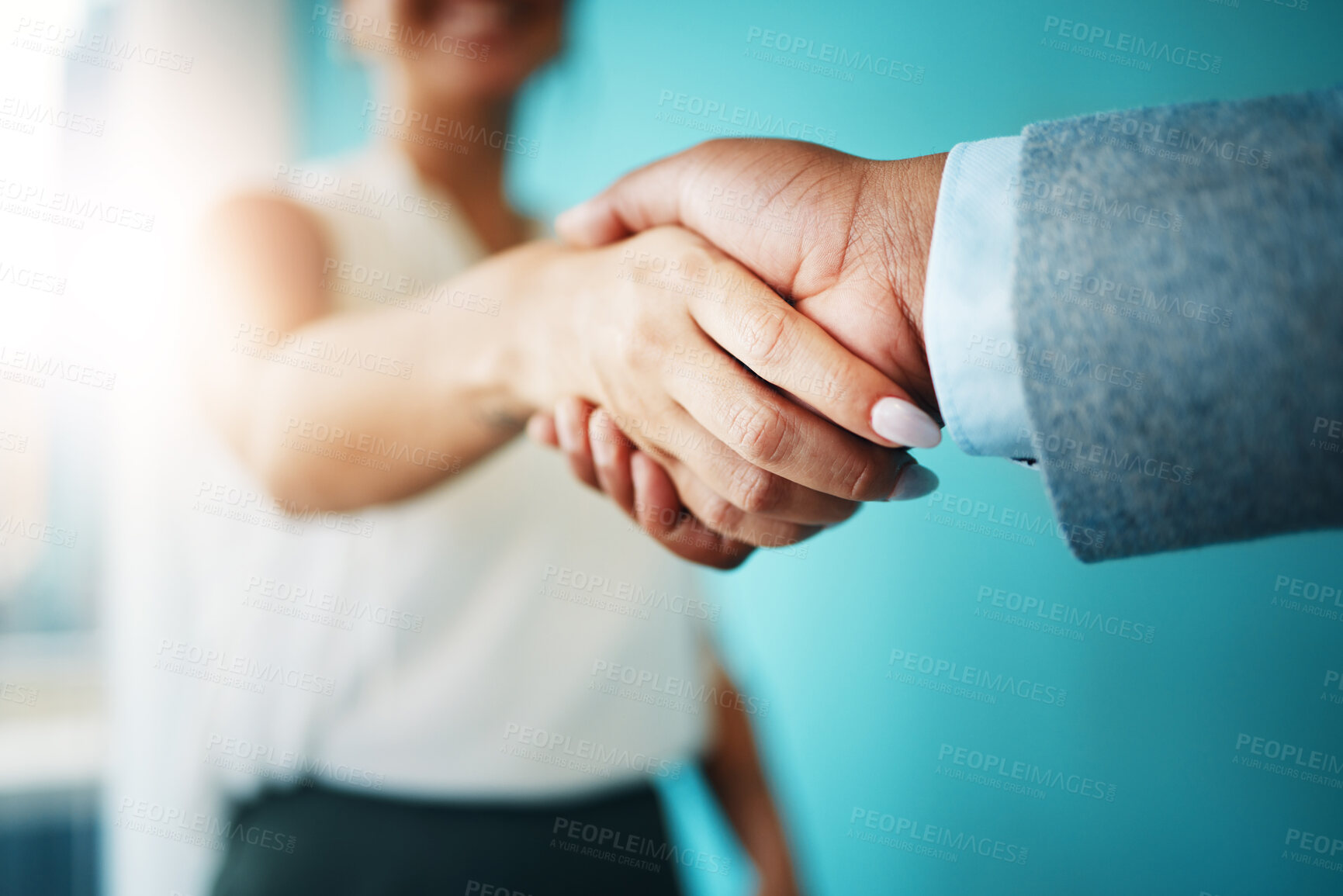 Buy stock photo Cropped shot of two unrecognisable businesspeople standing together in the office and shaking hands