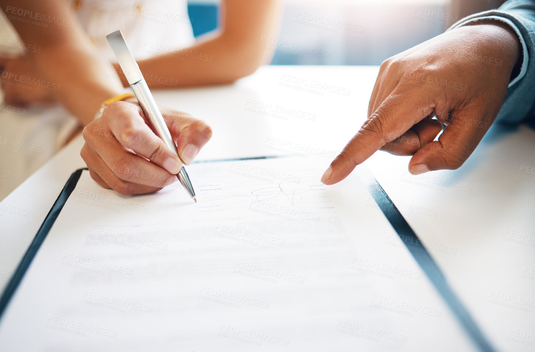Buy stock photo Cropped shot of two unrecognisable businesspeople signing a contract in the office
