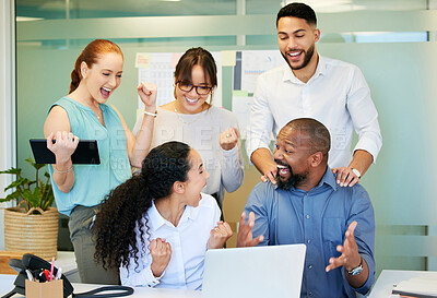 Buy stock photo Shot of a diverse group of businesspeople celebrating a success while using a laptop in the office